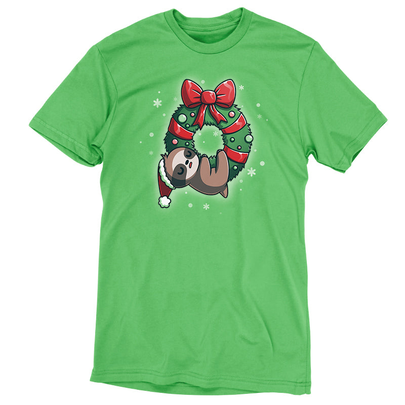 Premium Cotton T-shirt_TeeTurtle We Wish You a Lazy Christmas apple green t-shirt featuring a cartoon sloth in a Santa hat, snoozing while hanging from a festive wreath adorned with red ribbons and ornaments. 