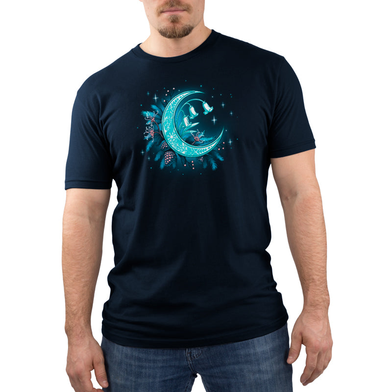 Premium Cotton T-shirt_TeeTurtle Winter Moon navy blue t-shirt featuring a magical glowing crescent moon adorned with floral patterns, bell flowers, pine cones, and evergreen branches against a dark celestial background. 