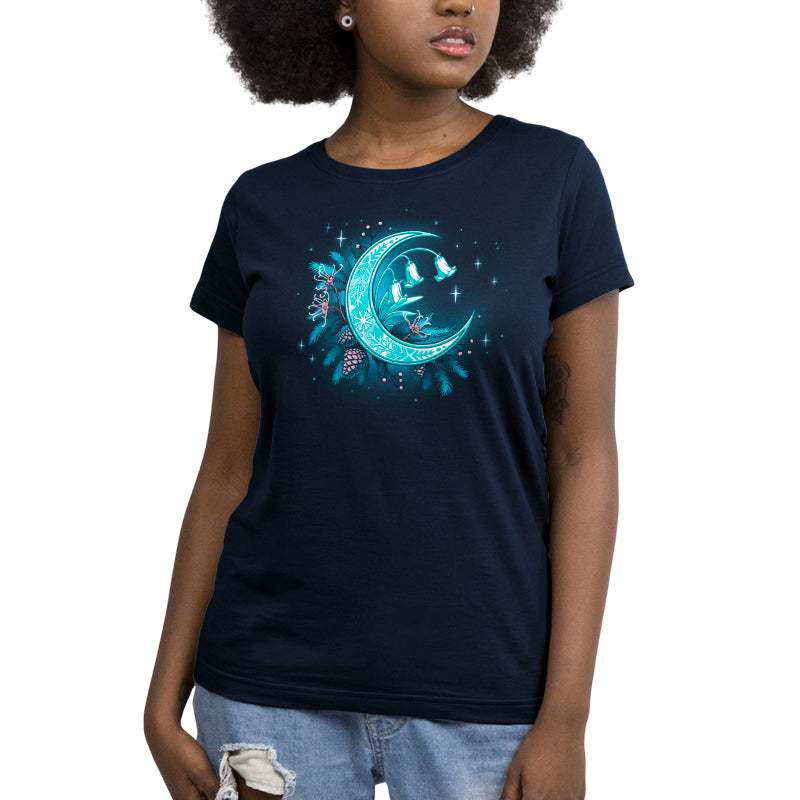 Premium Cotton T-shirt_TeeTurtle Winter Moon navy blue t-shirt featuring a magical glowing crescent moon adorned with floral patterns, bell flowers, pine cones, and evergreen branches against a dark celestial background. 