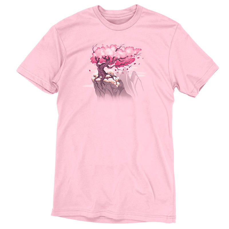 Premium Cotton T-shirt_TeeTurtle Sakura Tree pink t-shirt featuring an illustration of a pink cherry blossom tree on a rocky cliff with mountains in the background. Blossoms and petals are being blown in the wind. 