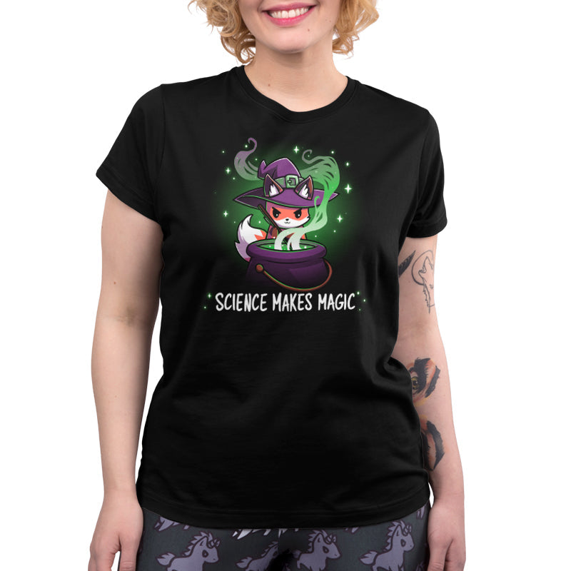 Premium Cotton T-shirt_TeeTurtle Science Makes Magic black t-shirt featuring a fantasy fox wearing a purple witch hat, stirring a cauldron with green smoke and sparkles rising. Text below reads, "SCIENCE MAKES MAGIC."