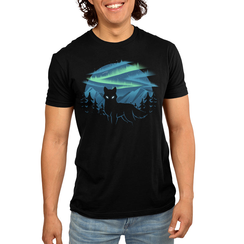 Premium Cotton T-shirt_A black apparel features a silhouette of a wolf with glowing eyes standing in front of a forest and mountains, with the wild aurora illuminating the night sky in the background. Made of super soft ringspun cotton, this Wild Aurora by monsterdigital is both comfortable and striking.