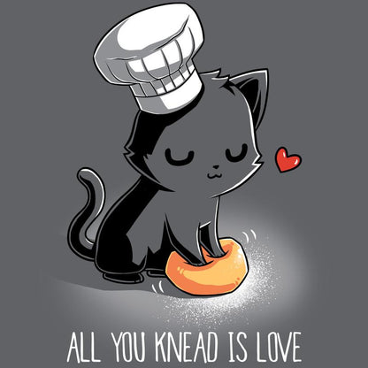 Premium Cotton T-shirt_A cartoon black cat wearing a chef's hat kneads a dough ball, with a red heart above its head, on this unisex tee. Caption reads: "All You Knead Is Love". Made of super soft ringspun cotton, this charcoal gray apparel called "All You Knead Is Love" by monsterdigital is perfect for cat lovers and baking enthusiasts alike.