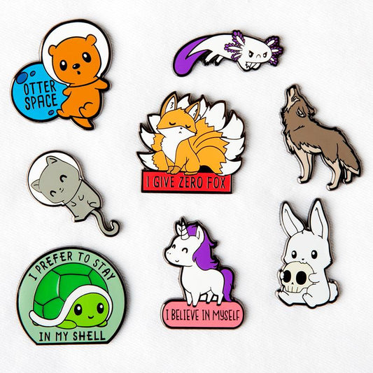 A clean set of TeeTurtle enamel pins featuring animals, including the Stay in My Shell Pin.