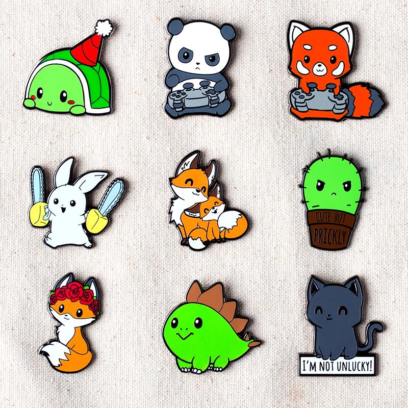 A collection of TeeTurtle enamel pins featuring various animals including the Cute But Prickly Pin.