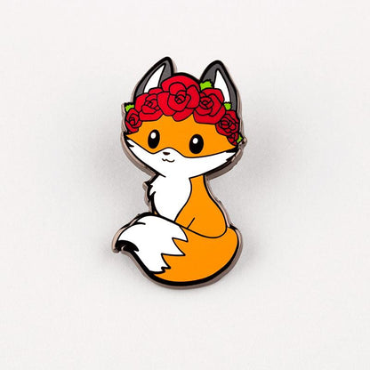 An Dia de los Foxes Pin enamel pin of a fox wearing a flower crown. (Brand: TeeTurtle)