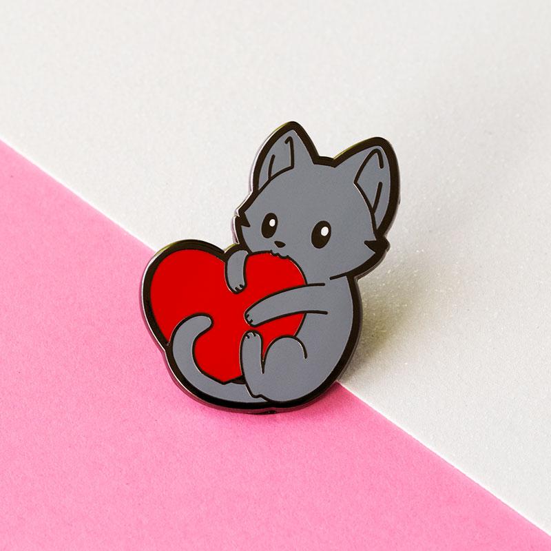 A "I Love Mew Pin" enamel pin featuring a red heart from TeeTurtle.