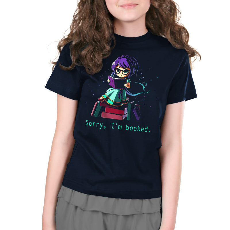 Premium Cotton T-shirt_TeeTurtle navy blue Sorry I'm Booked]. Featuring a girl sitting on a pile of books reading.