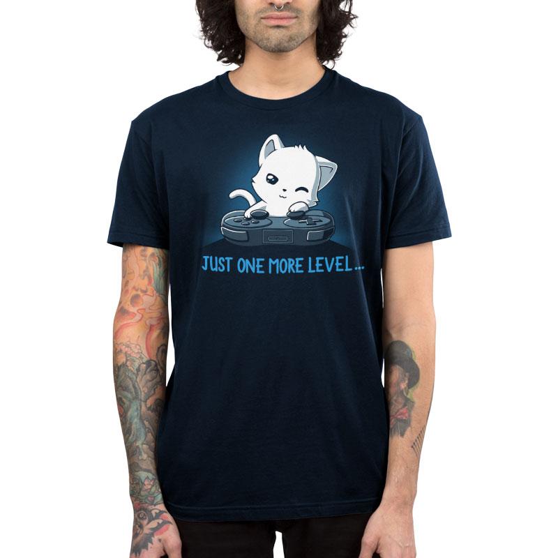 Premium Cotton T-shirt_TeeTurtle Just One More Level navy blue t-shirt featuring a cat falling asleep in front of a video game controller.