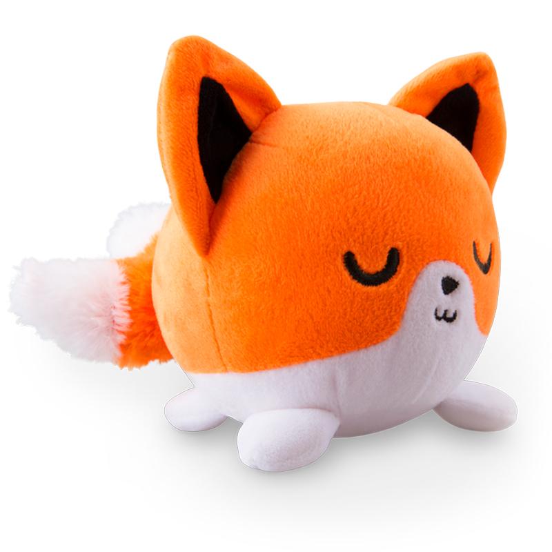 A snuggly TeeTurtle Kitsune plushie lying down on a white surface.