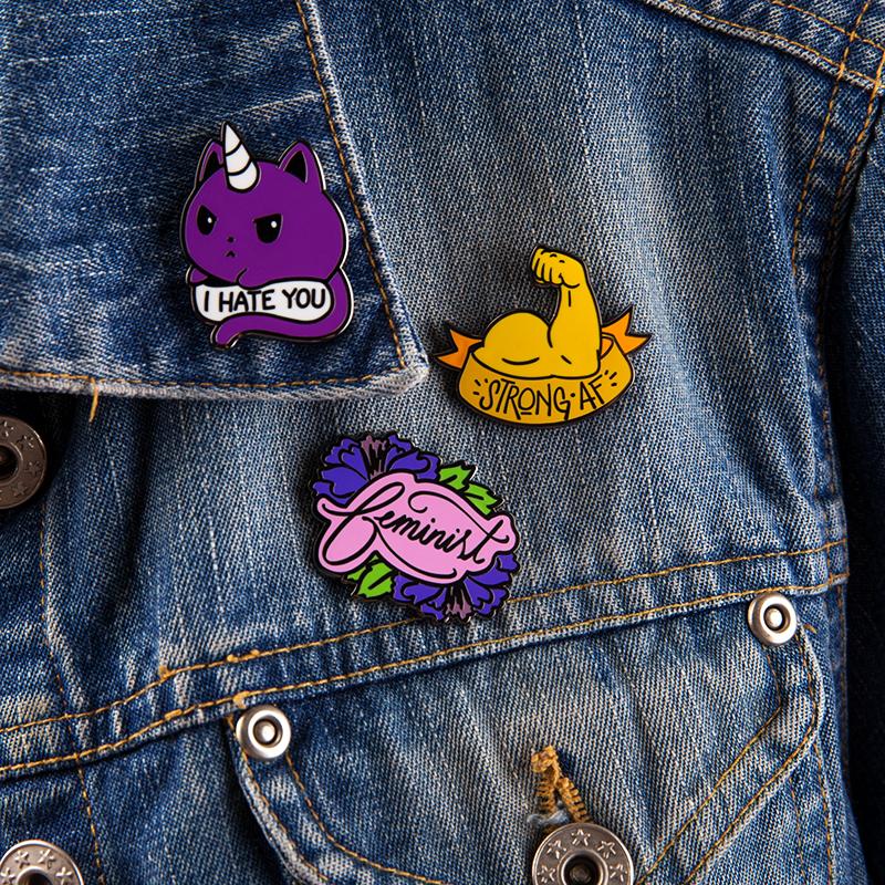 A pair of denim jackets adorned with TeeTurtle's Kittencorn Mini Pins.