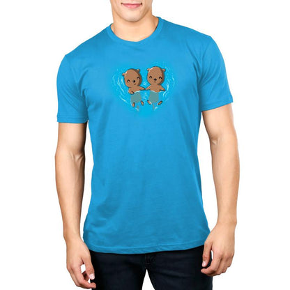 Premium Cotton T-shirt_Teeturtle My Otter Half cobalt blue t-shirt featuring two otters holding hands while floating on their backs in water, surrounded by ripples in a heart shape.