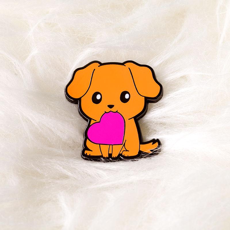 An orange dog with a pink heart on a white background, representing the TeeTurtle Puppy Love Pin.