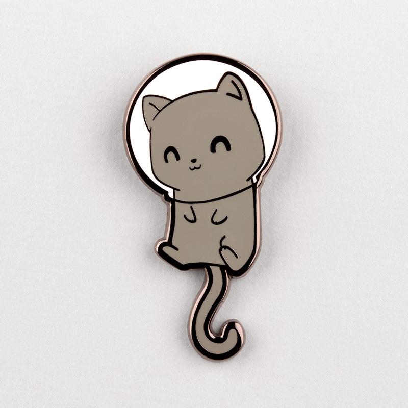 A TeeTurtle Space Cat Pin with a cat in a spacesuit featuring kittens.